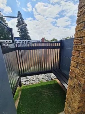 a wooden privacy fence with a small yard at LieBling Place in Cape Town