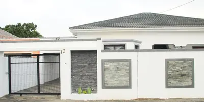 a white house with a gate in front of it at Optimum Stay Self Catering Accommodation - Junior Suite in Parow
