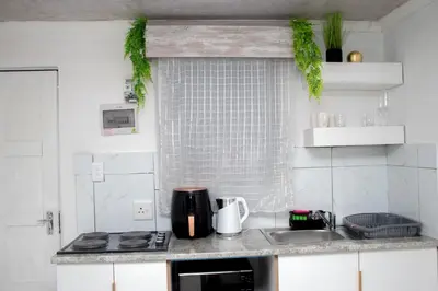 a kitchen with a sink and a counter top at Optimum Stay Self Catering Accommodation - Junior Suite in Parow