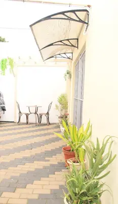 a patio with benches and potted plants at Optimum Stay Self Catering Accommodation - Junior Suite in Parow