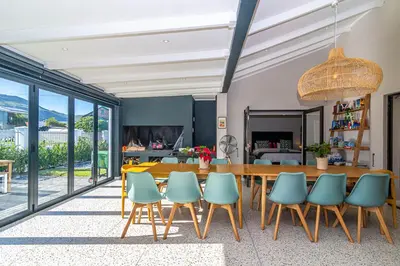 a dining room with a table and chairs at Pikkewyn Paradise in Hermanus