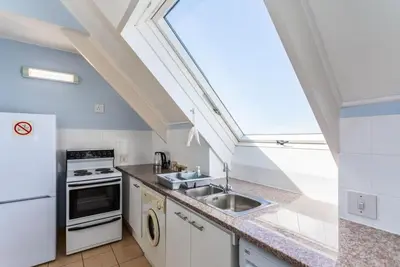 a kitchen with a sink and a skylight at Dolphin Beach H305 in Cape Town