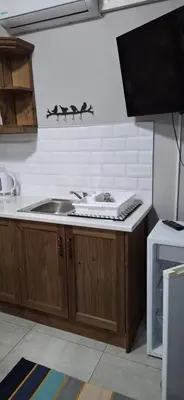 a kitchen with a sink and a stove at Firehouse guest suite no 3 in Wellington