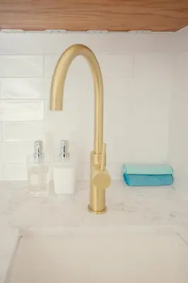 a kitchen sink with a gold faucet at Roubaix House - A Heritage Retreat in the Heart of Franschhoek in Franschhoek