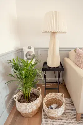 a living room with two baskets and a table with a lamp at Roubaix House - A Heritage Retreat in the Heart of Franschhoek in Franschhoek