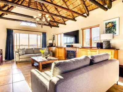 a living room with two couches and a table at Blue Crane House
