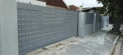 a privacy fence in front of a house at PEACEFUL SLEEP lodge in Goodwood