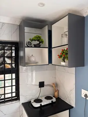 a kitchen with black and white cabinets and a stove at Browns villa and construction pty ltd in Cape Town