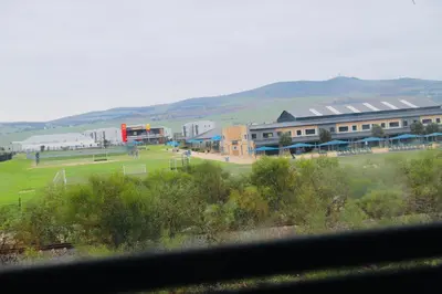 a view from a window of a field with buildings at Browns villa and construction pty ltd in Cape Town