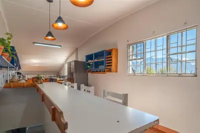 a kitchen with a large white counter and a window at Grietjiesdrif- Mountain Retreat in Rawsonville
