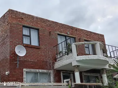 a brick building with a balcony on the side of it at Paradise view in Paarl