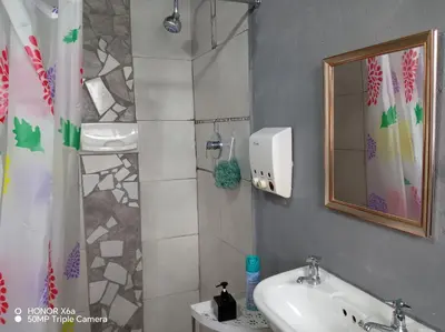 a bathroom with a sink and a mirror at Paradise view in Paarl