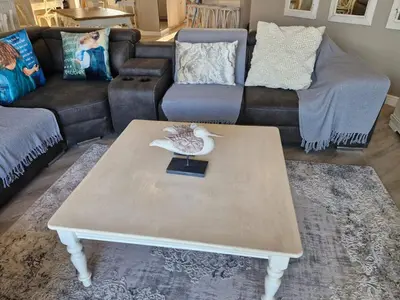 a living room with a coffee table and a couch at PENTHOUSE Luxury Apartment Amazing Sea Views CAPE TOWN in Strand