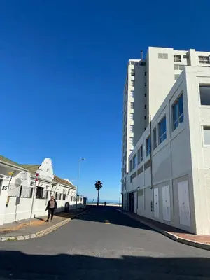 a person standing on a street next to a building at Studio Apartment 100 meters to Strand Beach in Strand