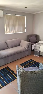 a living room with a couch and a bed at Firehouse selfcatering Garden Cottages no 5 in Wellington