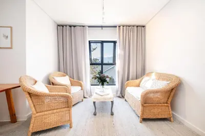 a living room with two chairs and a table at Olyfberg Rus in Paarl