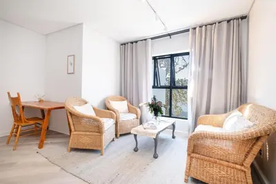 a living room with chairs and a table and a window at Olyfberg Rus in Paarl