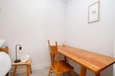 a wooden desk in a bedroom with a bed at Olyfberg Rus in Paarl
