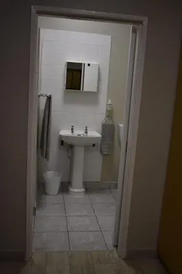 a bathroom with a sink and a toilet at Pualani Self Catering in Strand