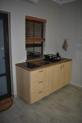 a kitchen with a stove and a counter top at Pualani Self Catering in Strand