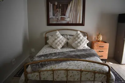 a bedroom with a bed with pillows on it at Pualani Self Catering in Strand