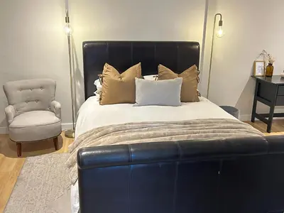 a bedroom with a large bed and a chair at Guest Suite in Stellenbosch in Stellenbosch