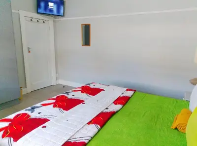 a bed with a quilt on it in a room at Neo & Ruks Guest house parow 1 in Avondale