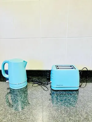 a toaster and a jug on a counter at Spanish Charm in the Heart of Century City Stylish Stay Near Canal Walk! in Cape Town