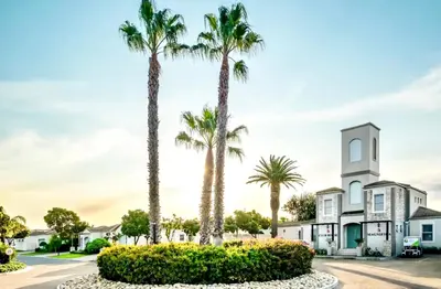 a group of palm trees in front of a building at Spanish Charm in the Heart of Century City Stylish Stay Near Canal Walk! in Cape Town