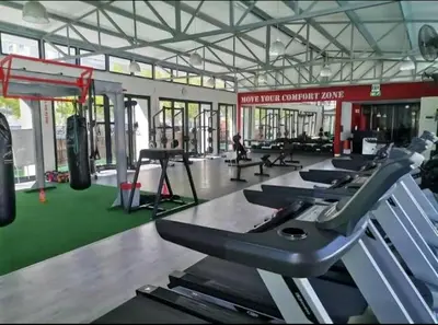 a gym with a row of treadmills and machines at Blouberg Luxury Oasis With Pool & Scenic Mountain Views in Cape Town