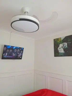 a white room with a ceiling light and a picture at Neats Accommodations in Cape Town
