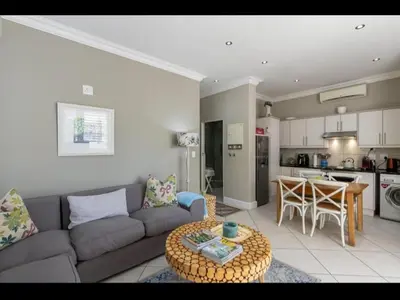a living room with a couch and a table at Merweda Wag-n-Bietjie on Dorp Street in Stellenbosch