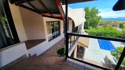 a view from the balcony of a house with a swimming pool at Somerset Breeze