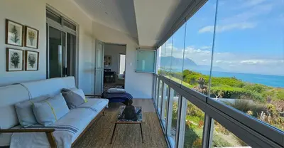 a living room with a couch and a view of the ocean at Tamatiebank in Hermanus