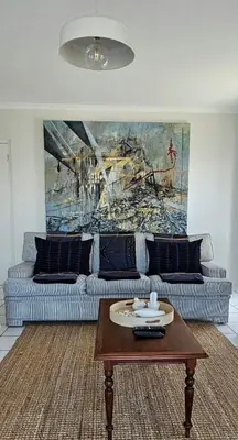 a living room with a couch and a coffee table at Tamatiebank in Hermanus