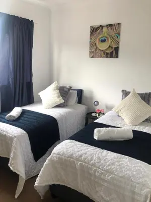two beds sitting next to each other in a bedroom at Brackenfell self catering accommodation in Brackenfell