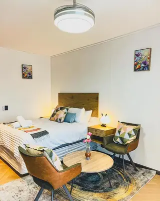 a bedroom with a bed and a table and chairs at Promise on Nine Palms Century in Cape Town