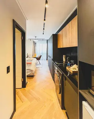 a room with a kitchen and a living room at Promise on Nine Palms Century in Cape Town