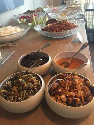 a table with bowls of food on a table at Leeu House in Franschhoek