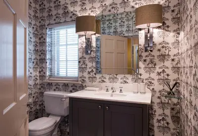 a bathroom with a toilet and a sink and a mirror at Leeu House in Franschhoek