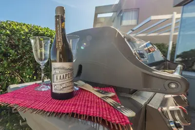 a bottle of wine sitting on top of a sewing machine at Dolphin View Cabana Beach House in Cape Town
