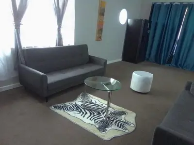 a living room with a couch and a zebra rug at Lucian Bed and Breakfast in Goodwood