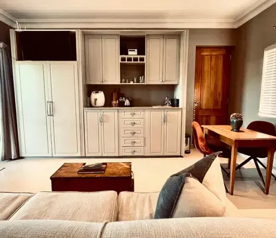 a living room with a couch and a table at Belle Vallee Guestroom 1 in Wellington