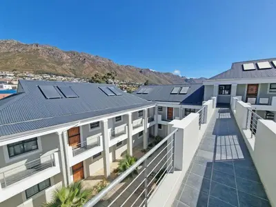an aerial view of a building with solar panels at 118 on the Bay in Gordonʼs Bay