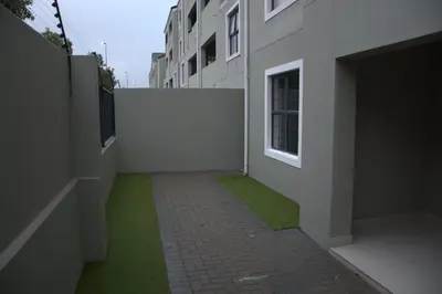 a hallway of a building with green grass at Avon Sand in Cape Town