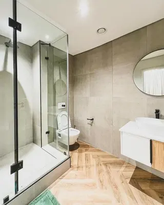 a bathroom with a toilet and a sink and a shower at Agape Apartment On park Century in Cape Town
