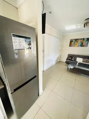 a kitchen with a stainless steel refrigerator in a room at Joy House in Cape Town
