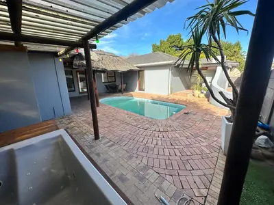 a swimming pool in the backyard of a house at Joy House in Cape Town