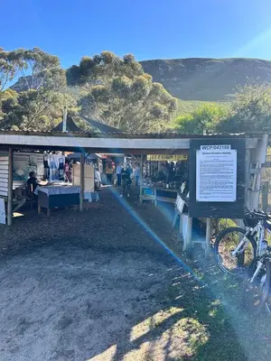 a building with a bike parked in front of it at Central Town Duplex with Pool, BBQ & Mountain View in Hermanus