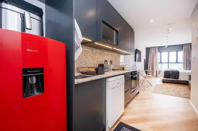 a kitchen with a red refrigerator in a room at Paarl Studio With Onsite Parking & Modern Comforts in Paarl